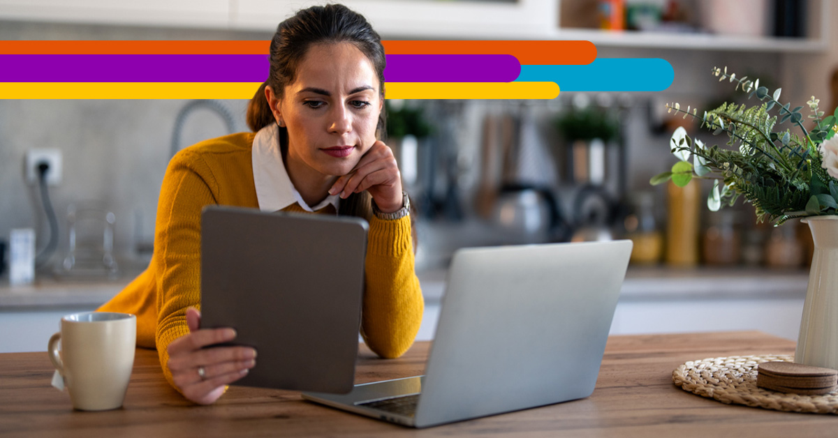woman leaning on kitchen counter looking at tablet with i3 Broadband fiber strands across the image